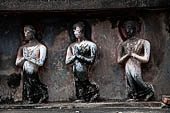 Thailand, Old Sukhothai - Wat Mahathat, stucco frieze runs around the base of the main chedi, it depicts a processions of monks with hands clasped in prayer. 